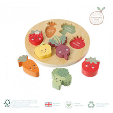 Load image into Gallery viewer, Wooden board has strawberry, pepper and beetroot while carrot, broccoli and tomato sit beside it. The gaps for the last three are shaped like the food, match the colour of the wooden block and read &quot;orange carrot, green broccoli, red tomato&quot;. Messaging around the photo reads &quot;sustainable wood, designed in the UK, entirely plastic free, 100% recyclable packaging&quot;. The FSC logo and fine print is in the bottom left. 
