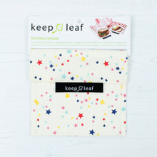 Load image into Gallery viewer, Stars baggie sits on a white wooden surface with card packaging. Packaging reads &quot;keep leaf reusable baggie&quot;. 

