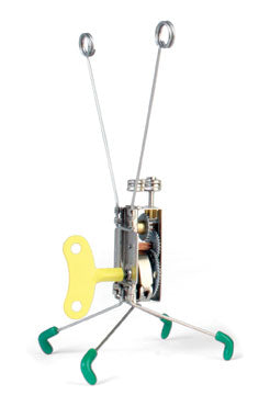 metal wind-up toy has a yellow wind up key, four legs with green boots, and two antenna with circles at the top. 