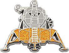 Load image into Gallery viewer, Close up of the pin badge shows detailed lines of the lunar module, colours are grey and gold.
