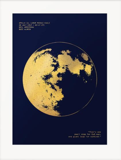 Dark blue print with a white border. Using gold foil an illustration of the moon is in the middle. Top left in gold foil reads 'Apollo 11, Lunar Module Eagle, 20 July 1969 - 20:17 UTC, Neil Armstrong, Buzz Aldrin.' in the bottom right is Neil Armstrong's quote in gold foil 