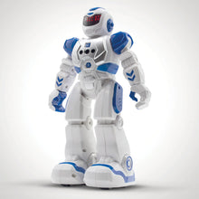 Load image into Gallery viewer, Robot has human body shape and is white with blue accents. The face is a black screen with red lights.

