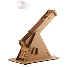 Load image into Gallery viewer, Catapult in action. Catapult is made of card, elastic bands and the item being catapulted is a ping pong ball.
