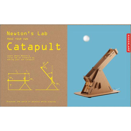Catapult kit is packaged in cardboard box. Half of the box is uncoloured, while the other half is light blue, featuring a picture of the catapult in action. Box reads 