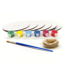 Load image into Gallery viewer, 6 white discs with dashed lines and two holes in the middle. 6 plastic paint pots all connected, green, yellow, two different blues, pink and red. Brush with blue handle and string in a bundle.
