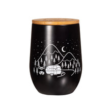 Load image into Gallery viewer, Black travel mug without handles. Bamboo lid. Design on mug shows a camper van parked in a forest with mountains in the background, and stars and moon in the sky.
