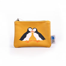 Load image into Gallery viewer, yellow coin purse with colourful illustration of two puffins touching beaks. white tag with RSPB logo and &#39;giving nature a home&#39; attached on right.
