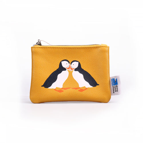yellow coin purse with colourful illustration of two puffins touching beaks. white tag with RSPB logo and 'giving nature a home' attached on right.