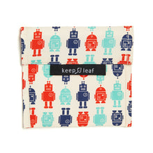 Load image into Gallery viewer, Fabric bag has fold over flap. Design has three different robot designs, two different blues and red. Base fabric is off-white. Black fabric tag reads &quot;keep leaf&quot;
