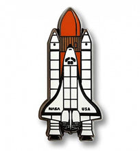 Load image into Gallery viewer, Close up of rocket and shuttle pin badge shows detailed lines. Shuttle has &#39;NASA&#39; and &#39;USA&#39; in capital black letters.
