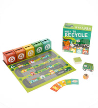 Load image into Gallery viewer, Play board is laid out with cards, dice, recycling truck and card recycling bins. Rush to Recycle box sits in background.
