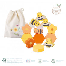 Load image into Gallery viewer, Stacked bees, honeycomb and flowers with a drawstring bag in the background. Bag has an illustration of a bee and butterfly flying around a sunflower with a ladybird on the ground.

