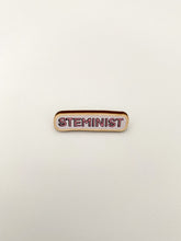 Load image into Gallery viewer, Pin badge is long thin horizontal oval which reads &#39;STEMINIST&#39; in all caps bubble letters. 

