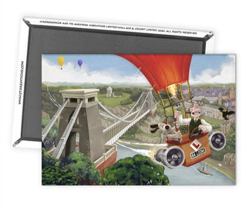 Magnet facing up is stacked on to a magnet facing down. Magnet image is in colour, Wallace (a white man) and Gromit (a dog) in a hot air balloon flying past the Clifton Suspension Bridge. Bottom magnet shows magnet covers most of the entire back, with a white border.