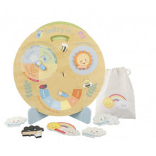 Load image into Gallery viewer, Weather clock propped on blue wooden stand with 5 wooden pieces with different types of weather (raining, thunder &amp; lightening, rainbow, snowing, windy). A drawstring bag to the right of the clock. The clock shows space for the day of the week, the month and season, the weather, and the temperature. The clock is decorated with ladybirds, bees and birds. 
