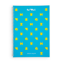 Load image into Gallery viewer, Blue notebook with yellow shapes. Spiral is white. At the top of the notebook, the We The Curious logo is in white. At the bottom of the notebook &quot;we the curious&quot; is upside down. 
