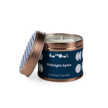 Load image into Gallery viewer, Rose gold tin candle with a navy blue label reads &quot;midnight spice scented candle&quot; and has the lid off. 

