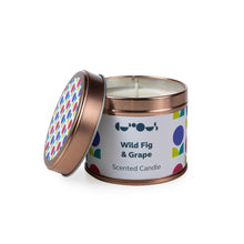 Load image into Gallery viewer, Candle in rose gold tin with white label reads &quot;wild fig &amp; grape scented candle&quot; with the lid tilted against the candle. 
