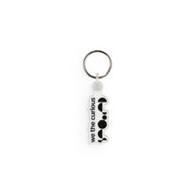 Load image into Gallery viewer, Keyring design is the We The Curious logo in black and white. 
