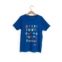 Load image into Gallery viewer, Navy t-shirt shows different coloured shapes with white lines on top. We The Curious logo is in bottom corner. 
