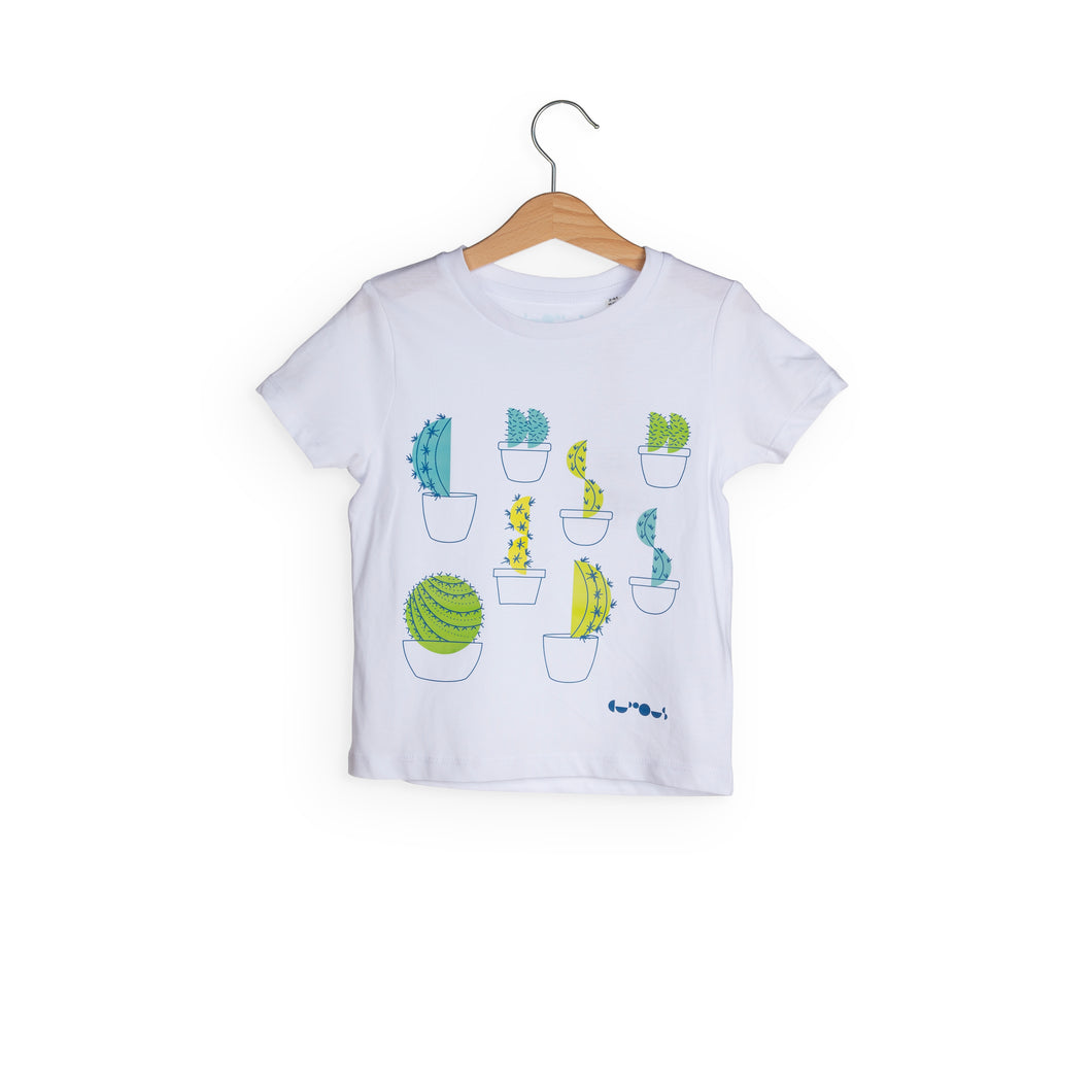 White t-shirt with 8 different cactus designs with different shades of green. We The Curious logo in navy blue is in bottom right. 