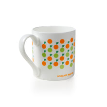 Load image into Gallery viewer, Mug from the other side shows the same pattern, but underneath is the name &quot;we the curious&quot; upside down in orange. 
