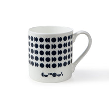 Load image into Gallery viewer, White mug shows dark blue moon phases pattern with the We The Curious logo underneath also in dark blue. 
