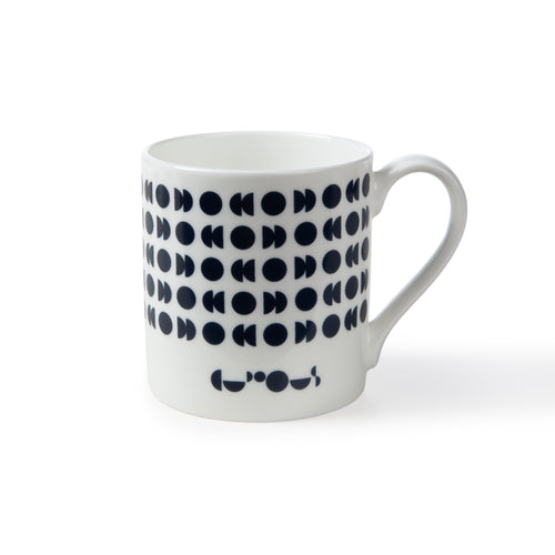 White mug shows dark blue moon phases pattern with the We The Curious logo underneath also in dark blue. 