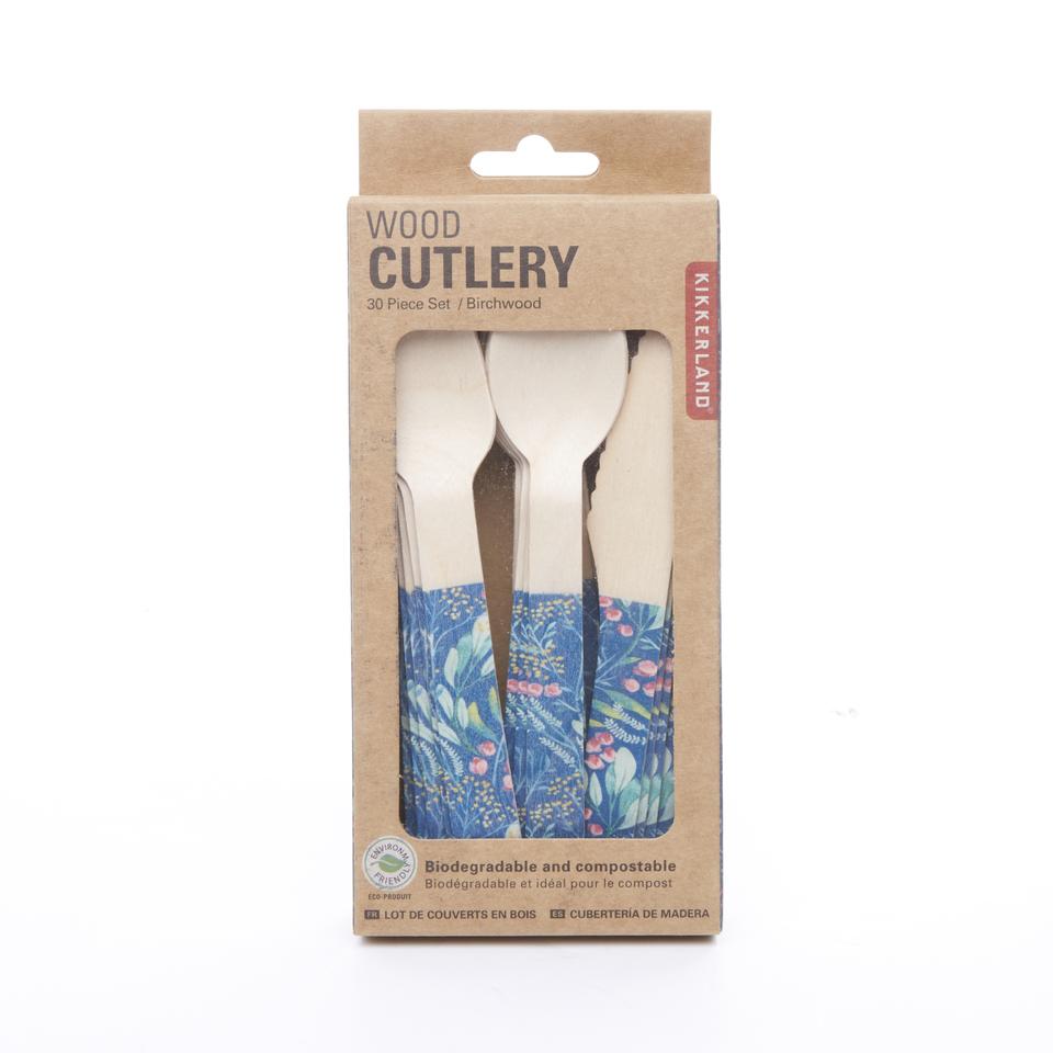 Wooden cutlery sits within cardboard box with cut out window. Each utensil has navy blue handle with floral design. Box reads 