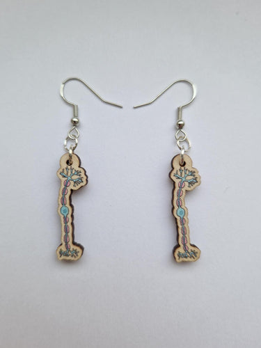 Dangly wooden earrings have design of a brain neuron in blue and pink colours. They are attached to a silver earring.